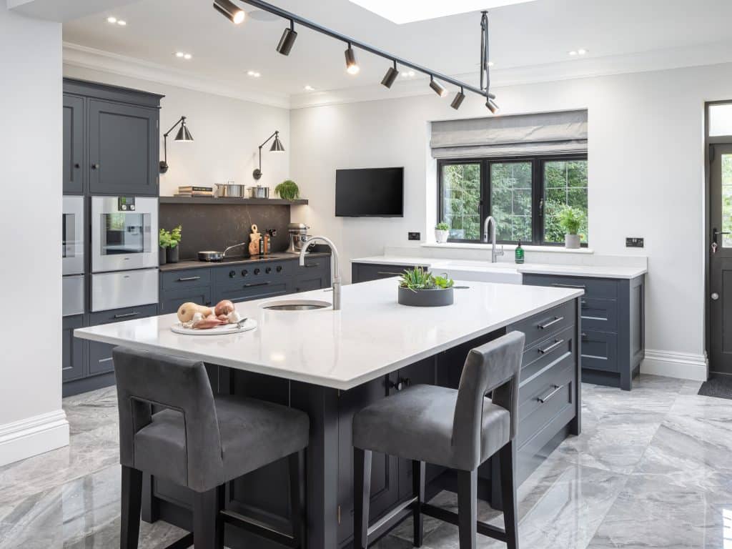 Chef's prep kitchen with kitchen island with sink and Gaggenau oven stack