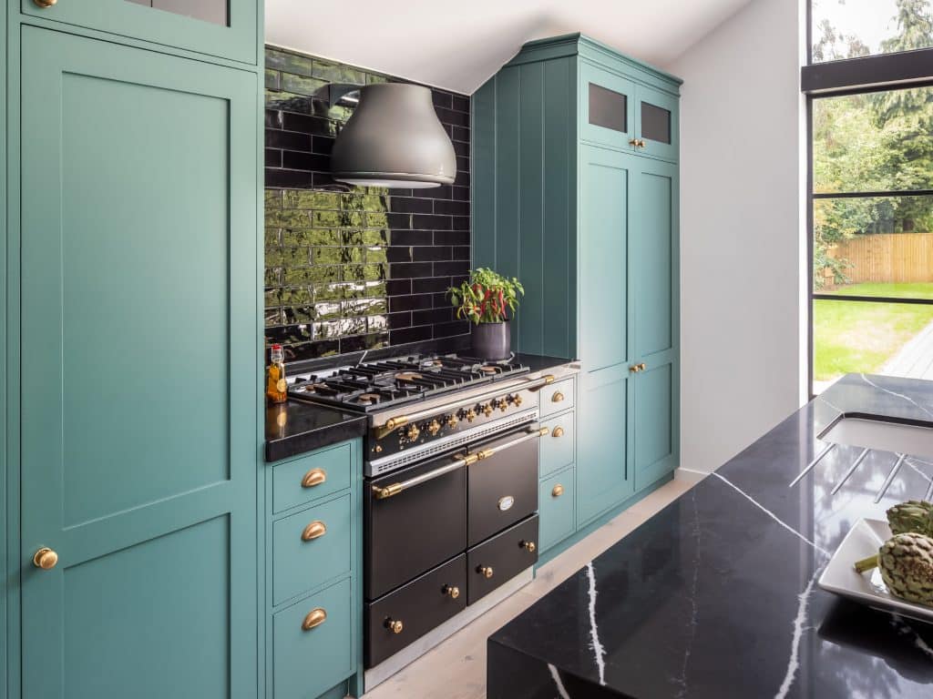 Luxury shaker kitchen wih green painted cabinery and lacanche range oven