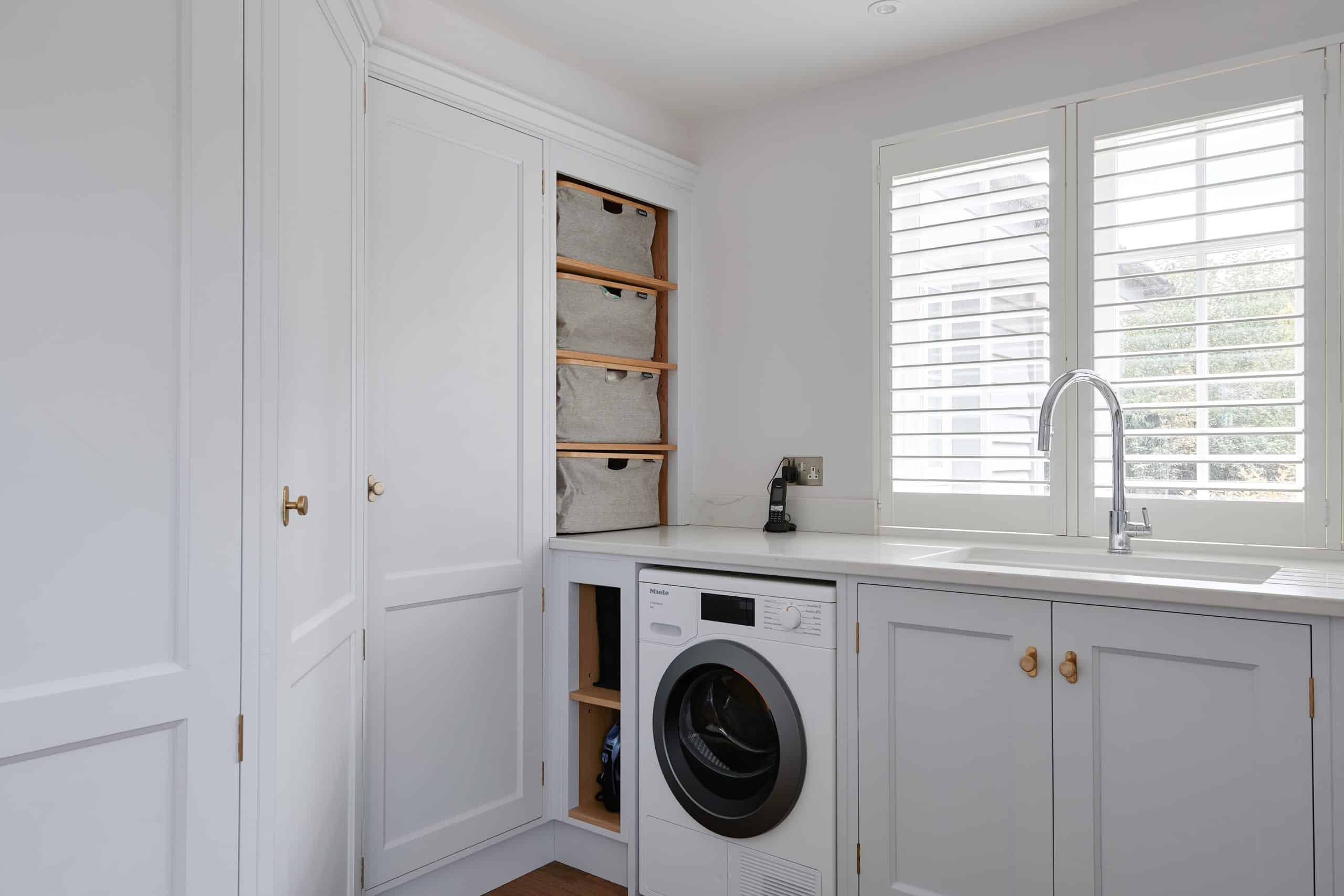 Utility room with Miele washing machine and shelving