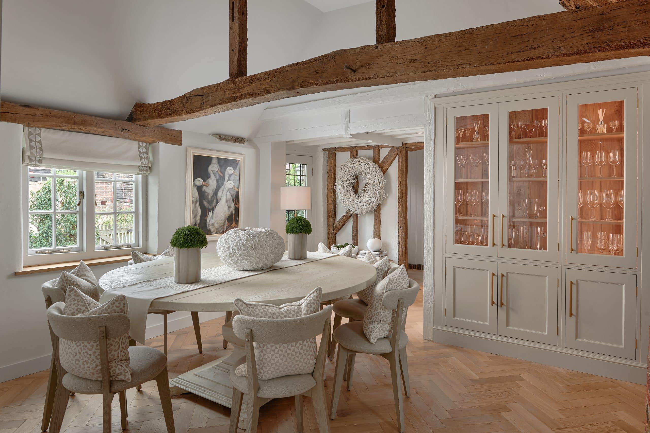 Bespoke dining room in a country cottage in Kent with fireplace and handmade cabinetry