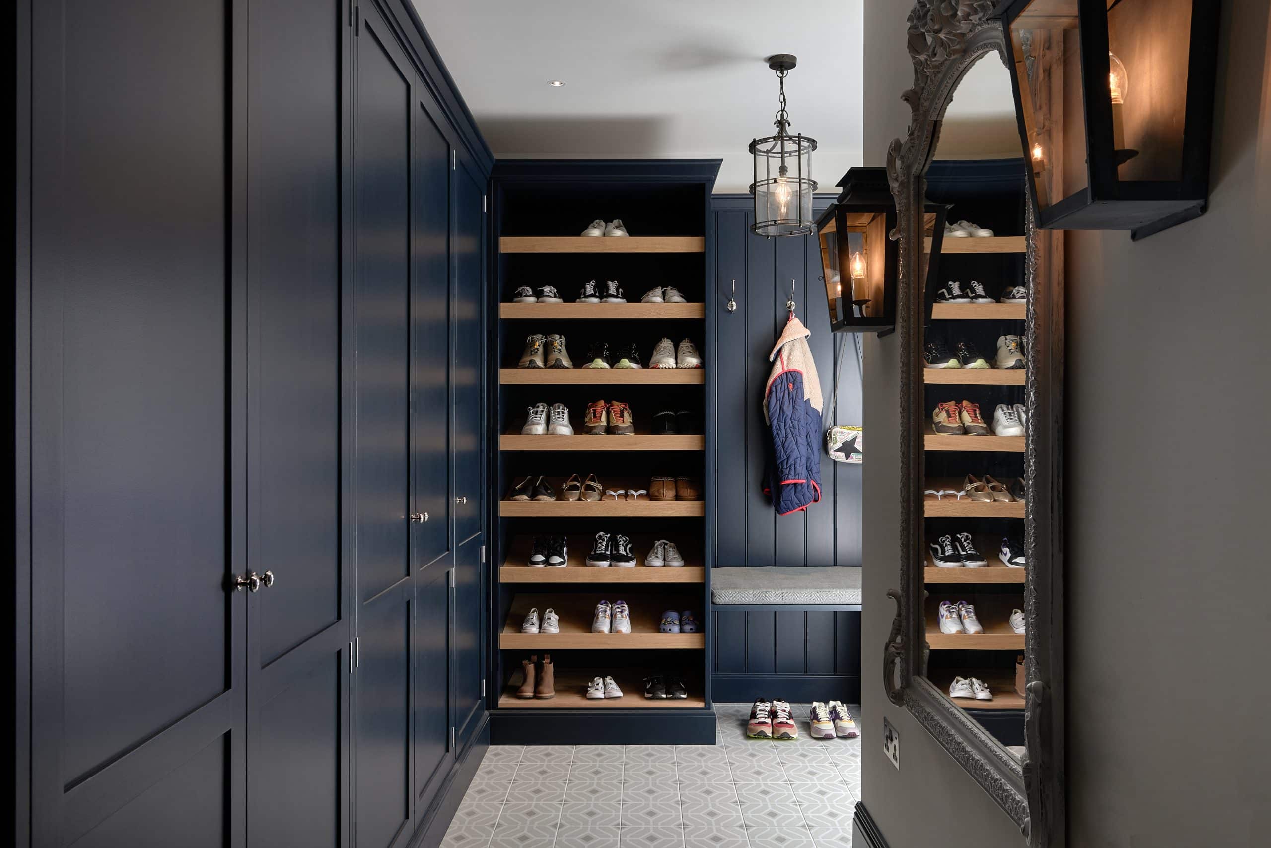 Dark blue handmade boot room with bench seating.