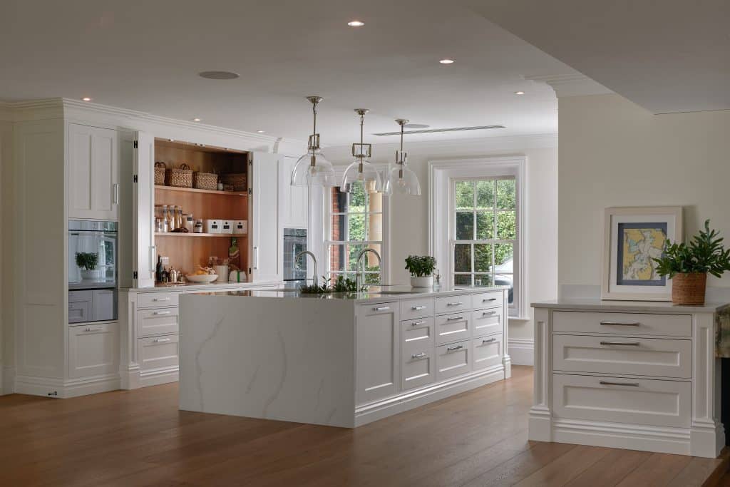 White hand-painted kitchen with breakfast pantry and BORA hob and handmade cabinetry.