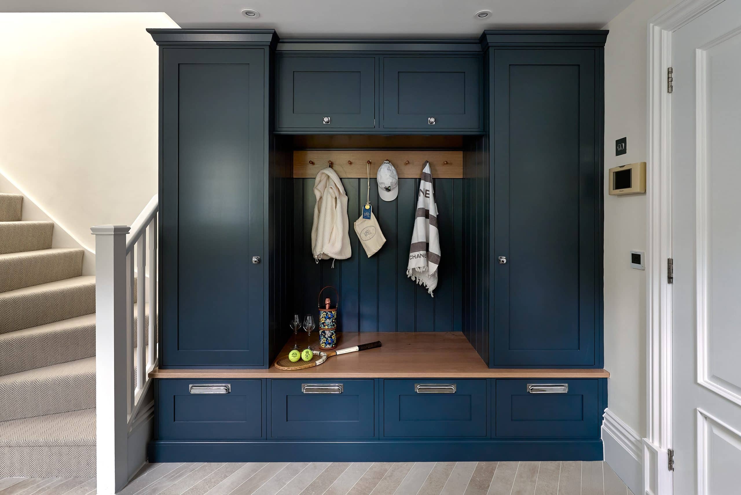 Bespoke luxury boot room with handmade cabinetry and a dog shower