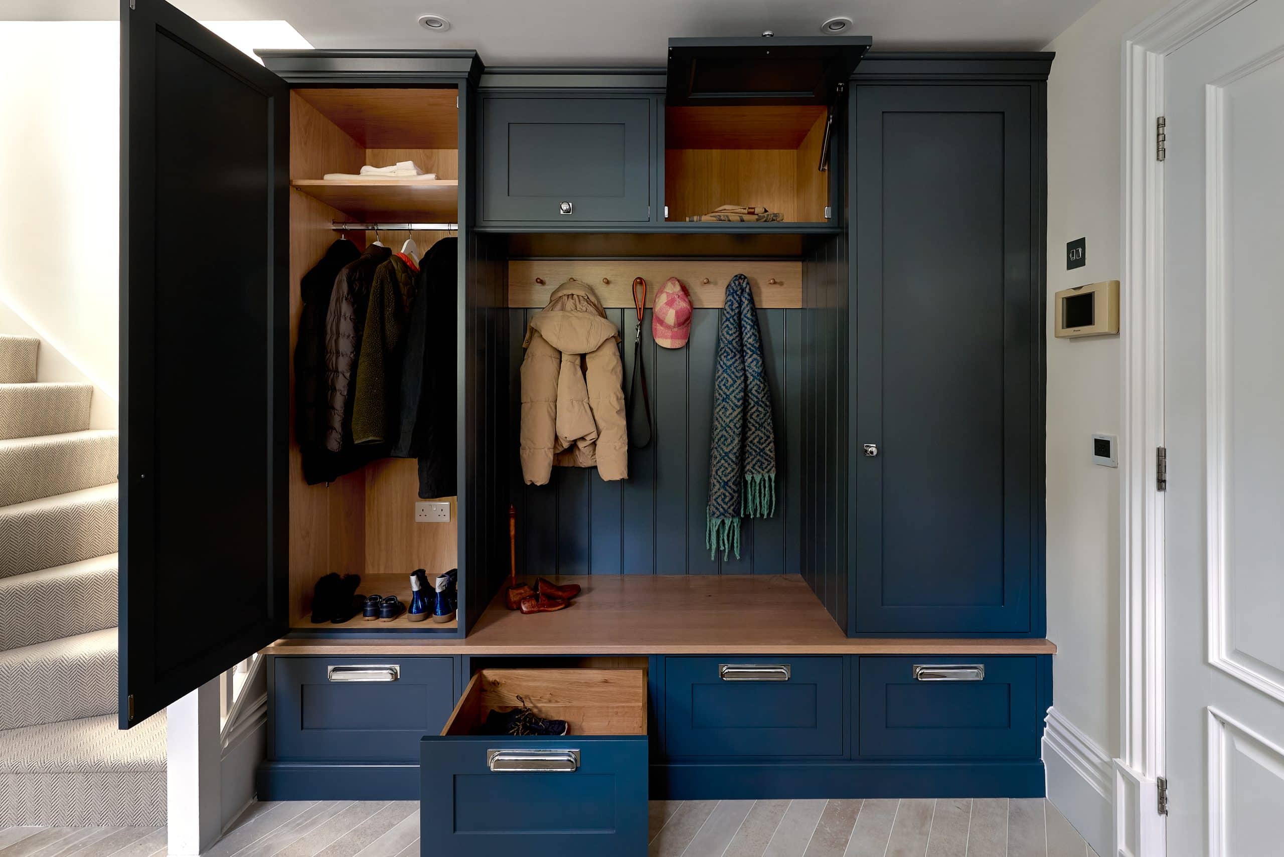 Bespoke luxury boot room with handmade cabinetry and a dog shower