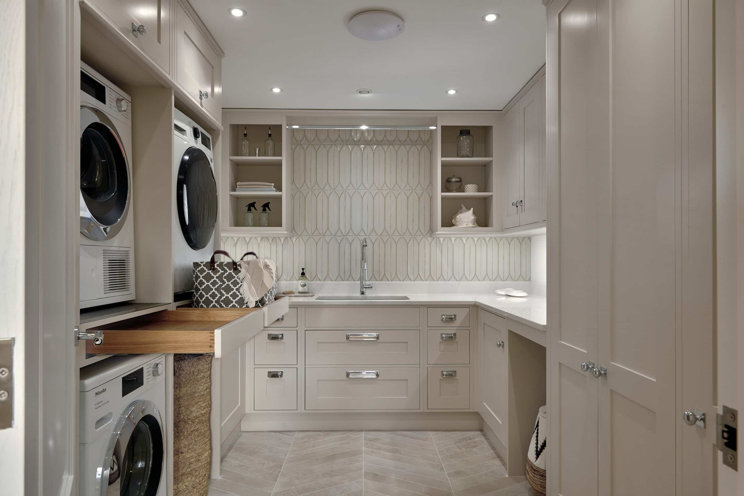 Bespoke utility room with sink, Miele appliances and a hidden pull out shelf.